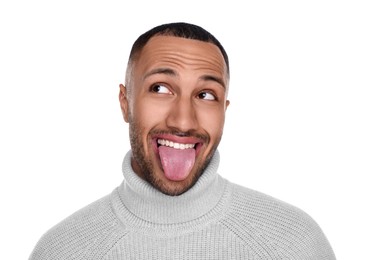 Happy young man showing his tongue on white background