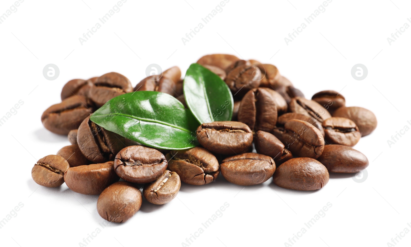 Photo of Roasted coffee beans and fresh green leaves on white background