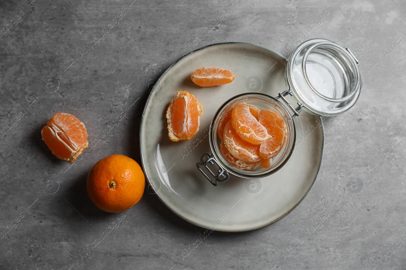 Photo of Fresh ripe tangerines on grey table, flat lay