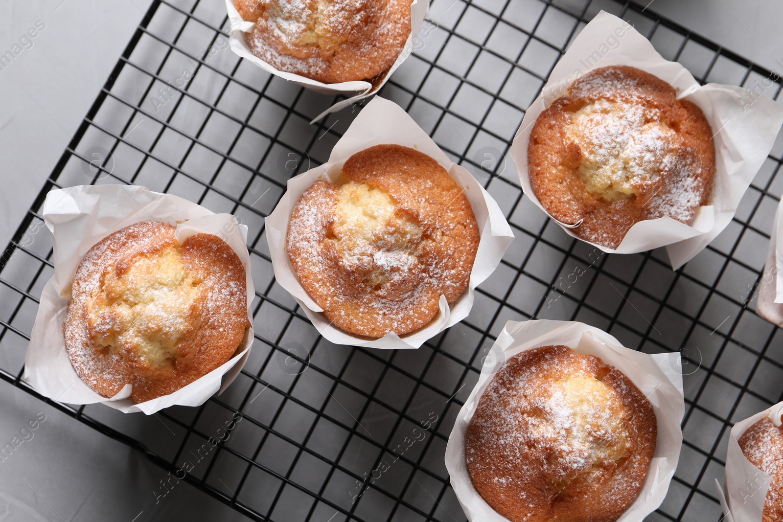 Photo of Delicious muffins on grey table, flat lay