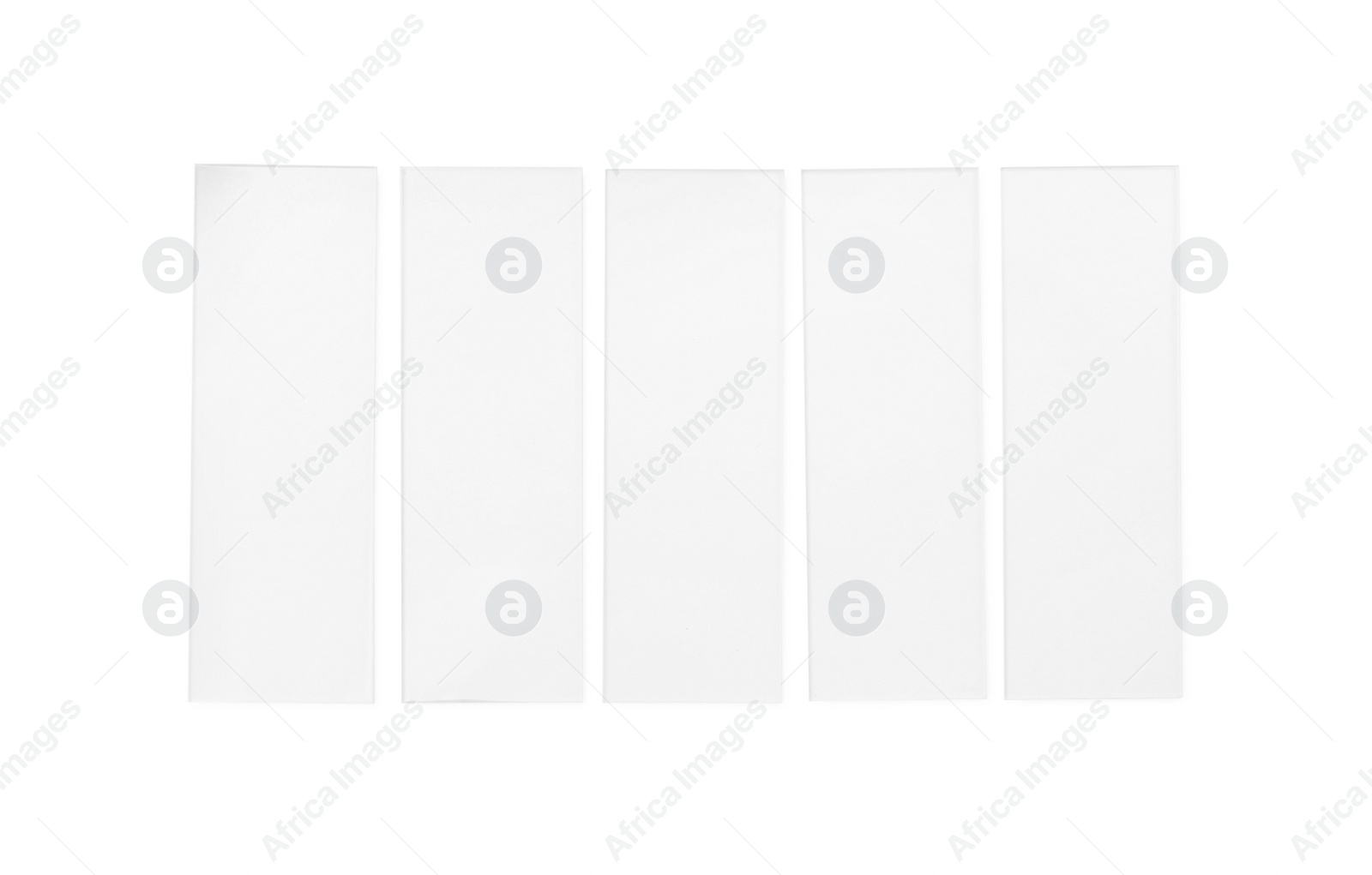 Photo of Row of microscope slides on white background, top view