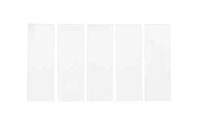 Photo of Row of microscope slides on white background, top view