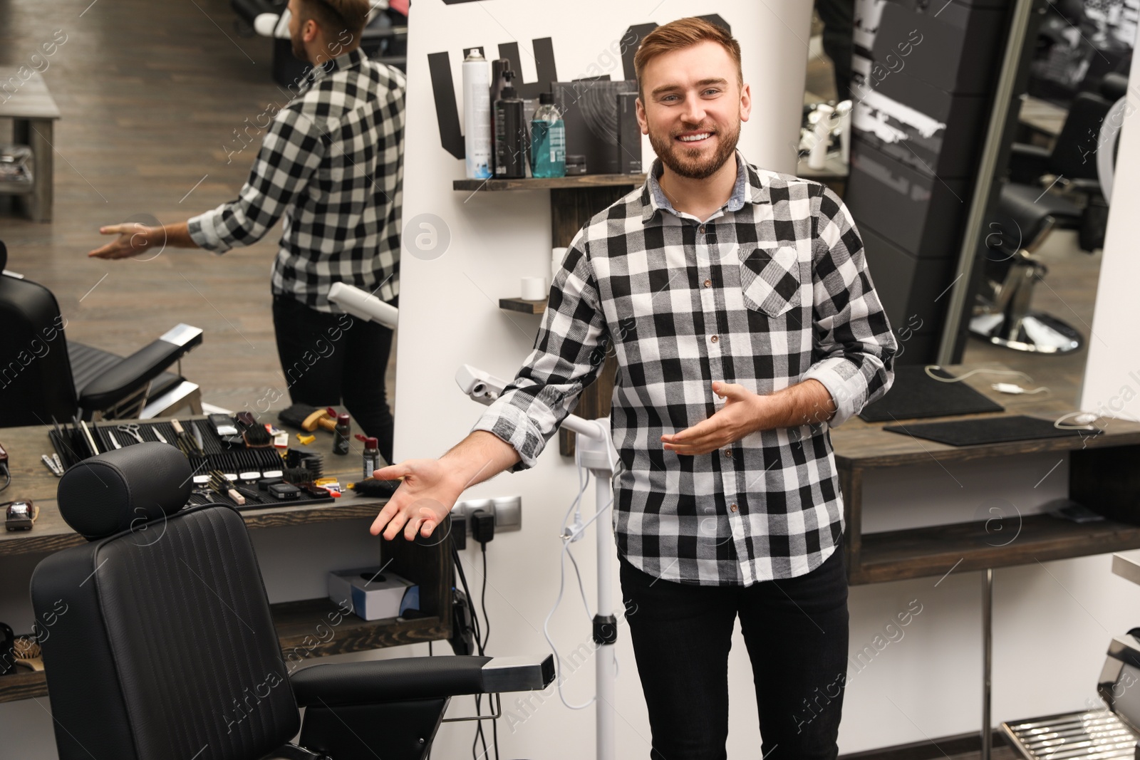 Photo of Young business owner in his barber shop