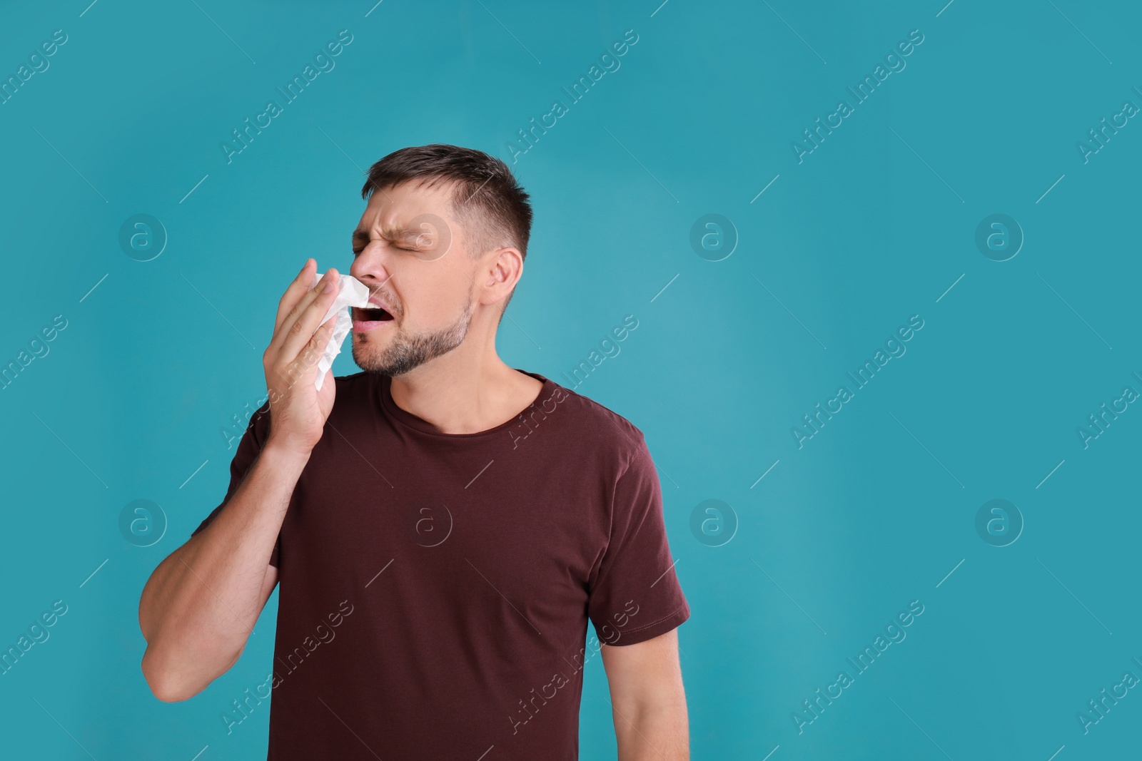 Photo of Man suffering from allergy on blue background. Space for text