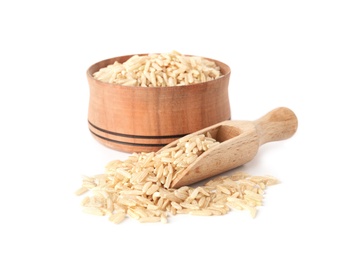 Photo of Bowl and scoop with uncooked brown rice on white background