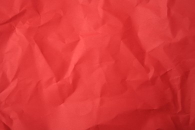 Photo of Sheet of crumpled red paper as background, top view