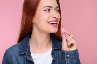 Beautiful woman with bubble gum on pink background