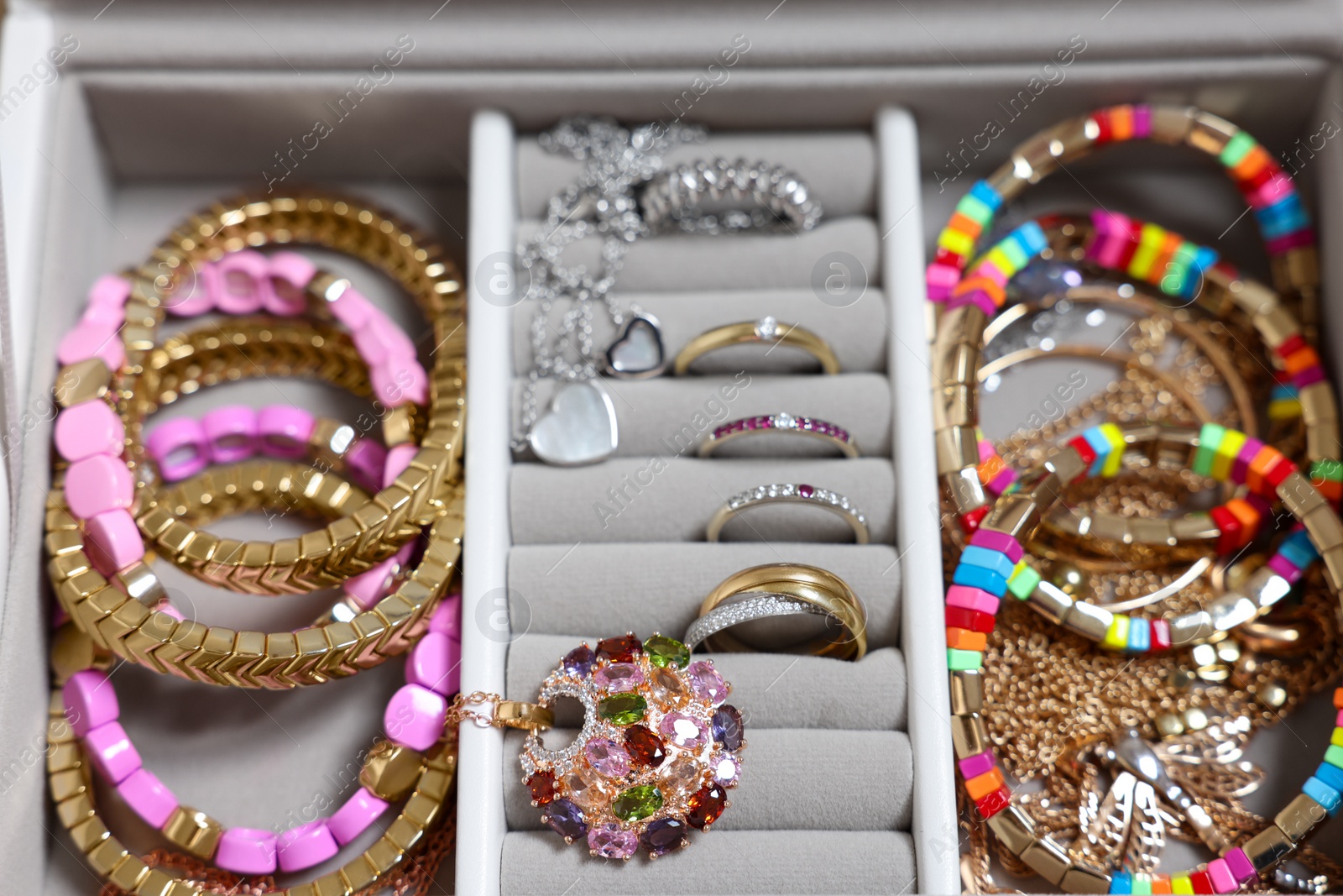 Photo of Jewelry box with beautiful bracelets and other accessories, closeup