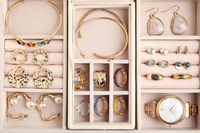 Photo of Jewelry box with stylish golden bijouterie, top view