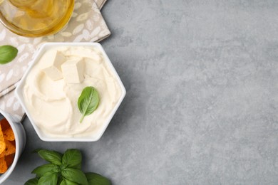 Photo of Delicious tofu sauce and basil on grey table, flat lay. Space for text