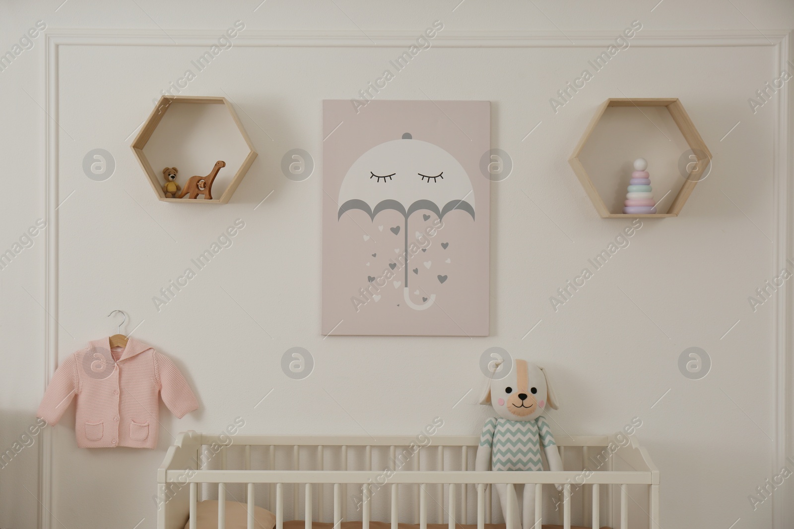 Photo of Modern baby room interior with crib and toys