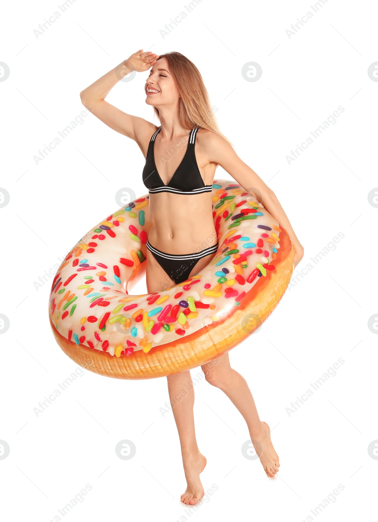 Photo of Beautiful young woman in stylish bikini with doughnut inflatable ring on white background