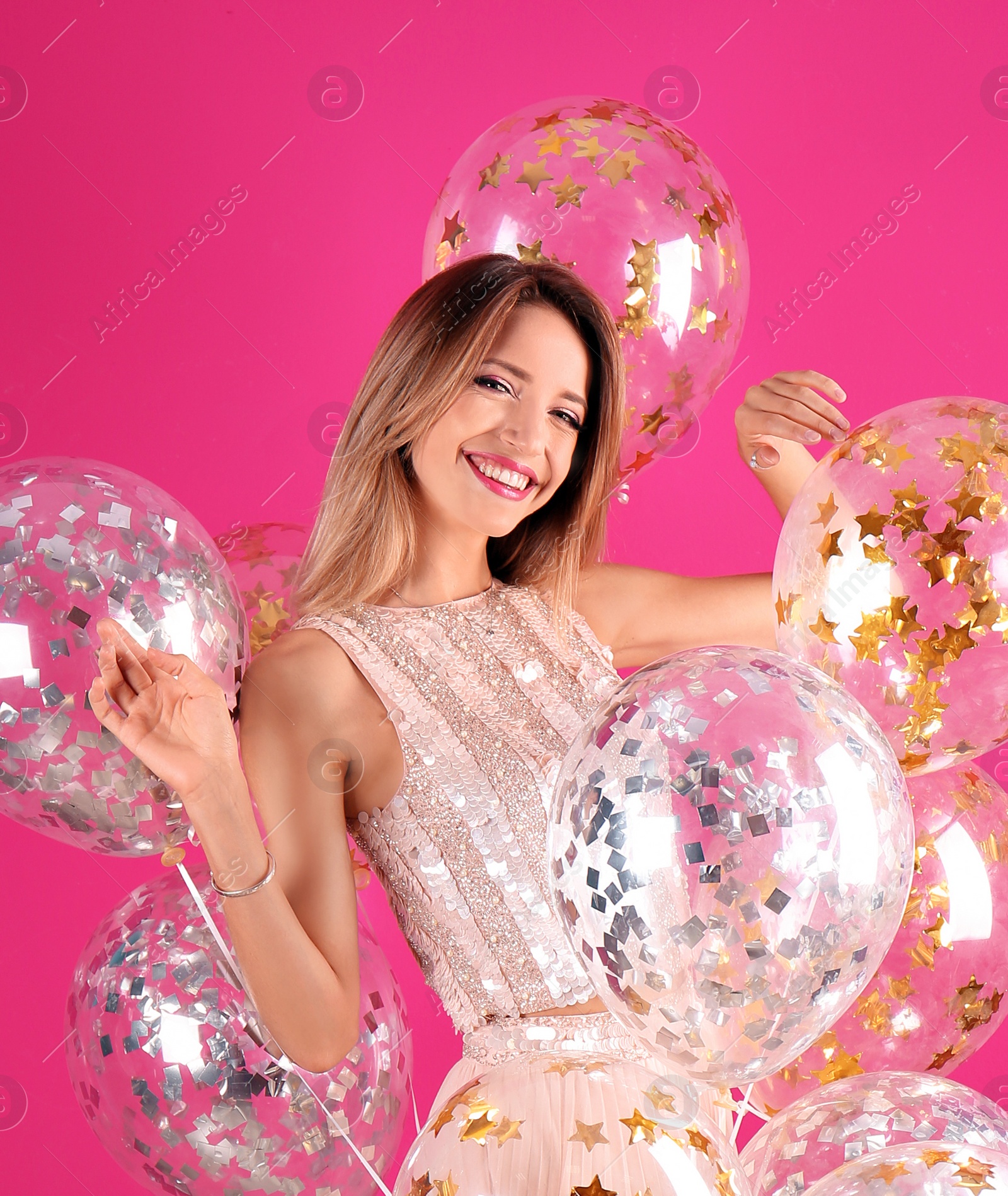 Photo of Young woman with air balloons on color background