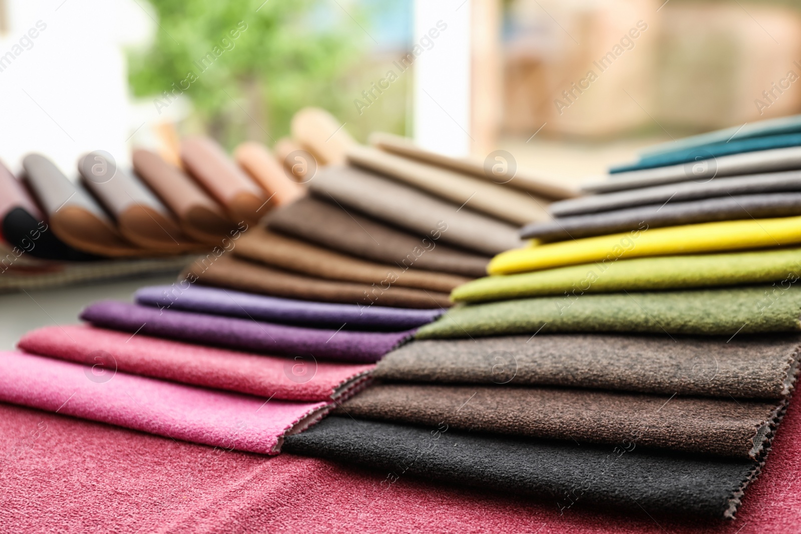 Photo of Fabric samples of different colors for interior design on table