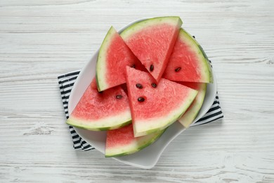 Photo of Delicious fresh watermelon slices on white wooden table, top view