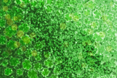 Image of St. Patrick's Day celebration. Clover leaves on green background, bokeh effect