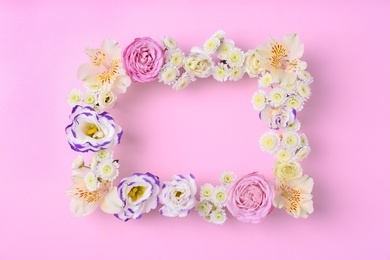 Photo of Frame of fresh flowers on wooden background, top view. Space for text