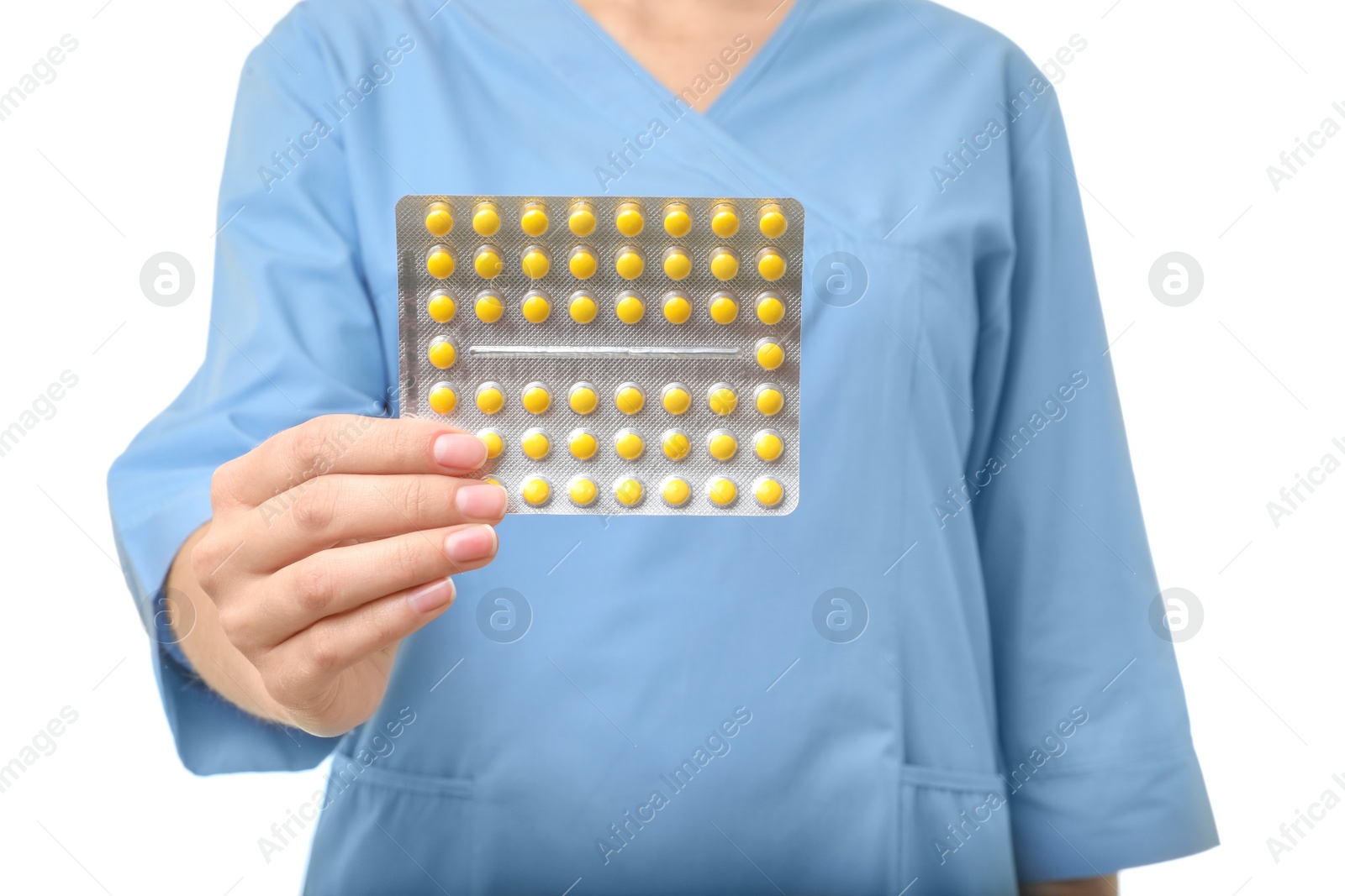 Photo of Female doctor holding pills on white background, closeup. Medical object