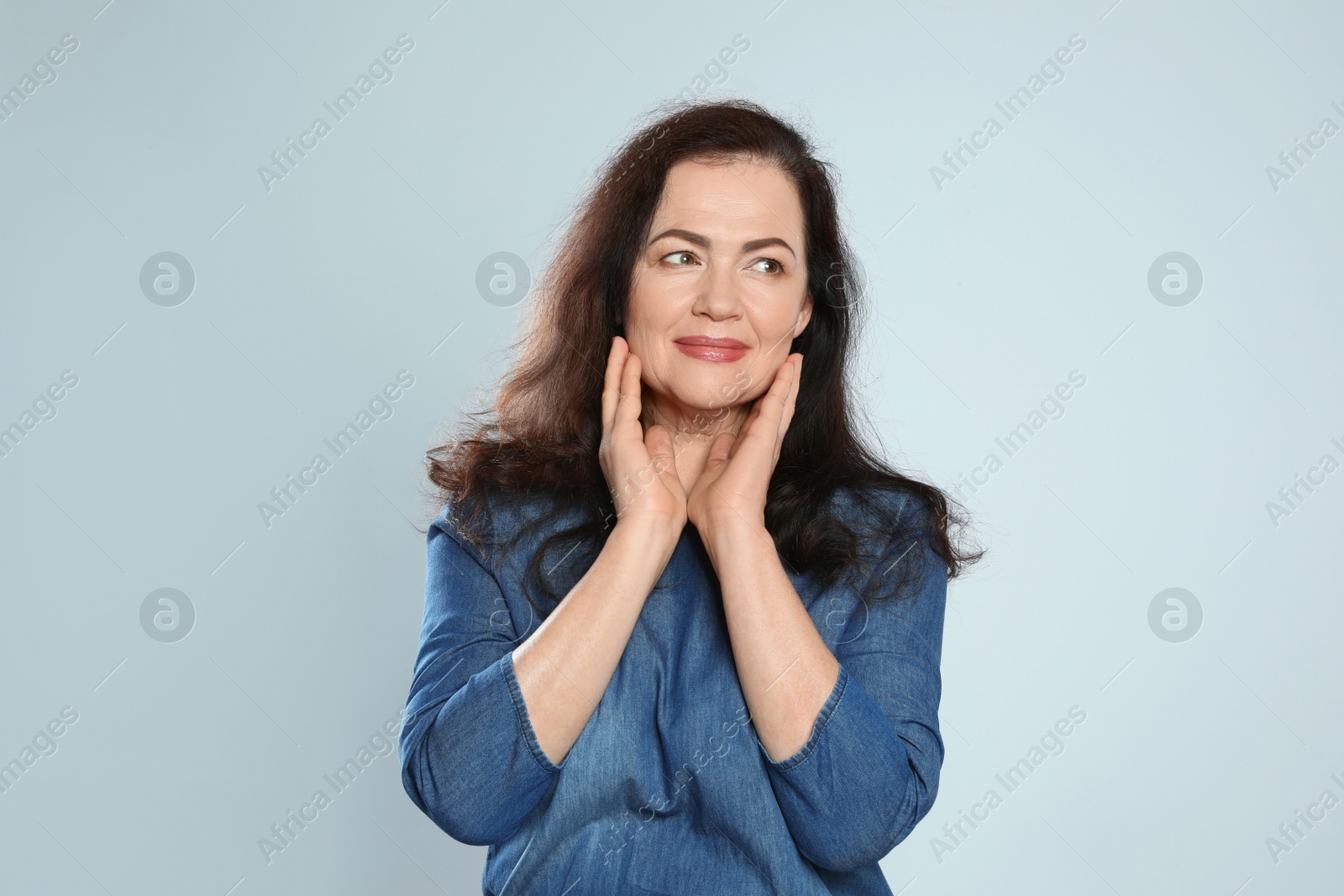 Photo of Portrait of mature woman with beautiful face on grey background