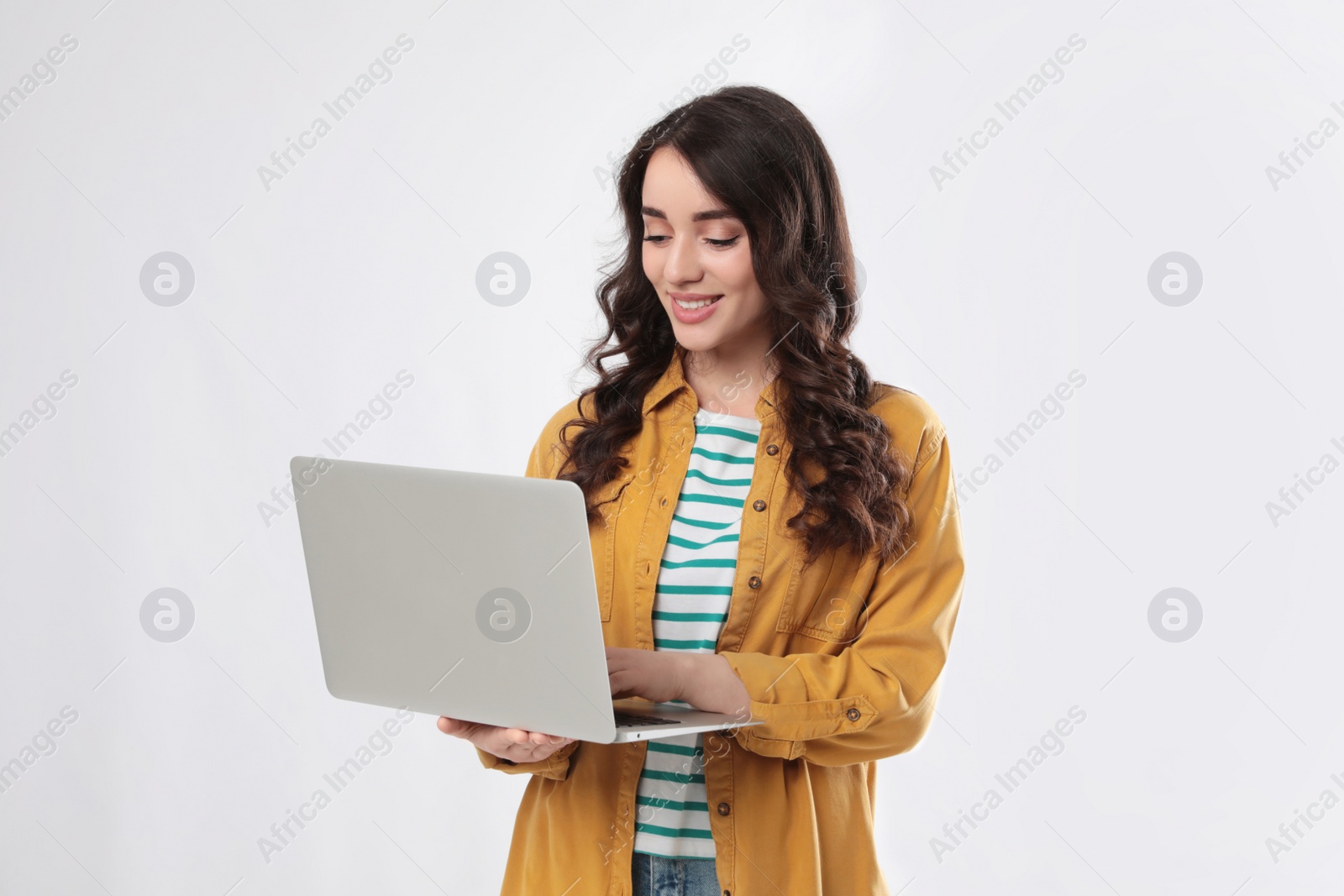 Photo of Young woman with laptop on white background