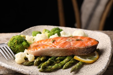 Photo of Healthy meal. Tasty grilled salmon with vegetables served on table, closeup