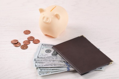 Pension certificate with American money and piggybank on white wooden background