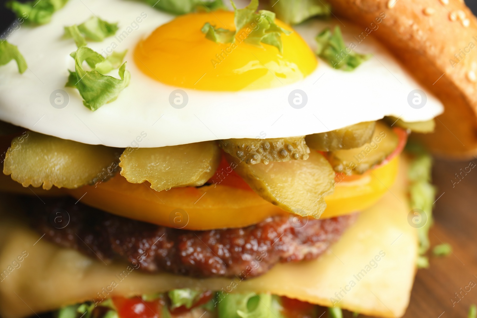 Photo of Closeup view of tasty burger with fried egg