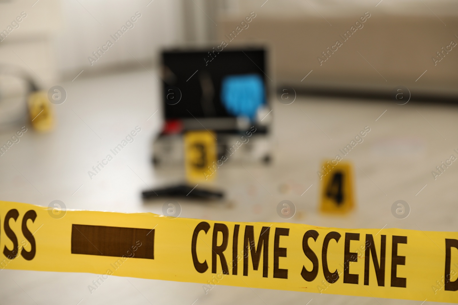 Photo of Crime scene with evidences and criminologist case, focus on yellow tape