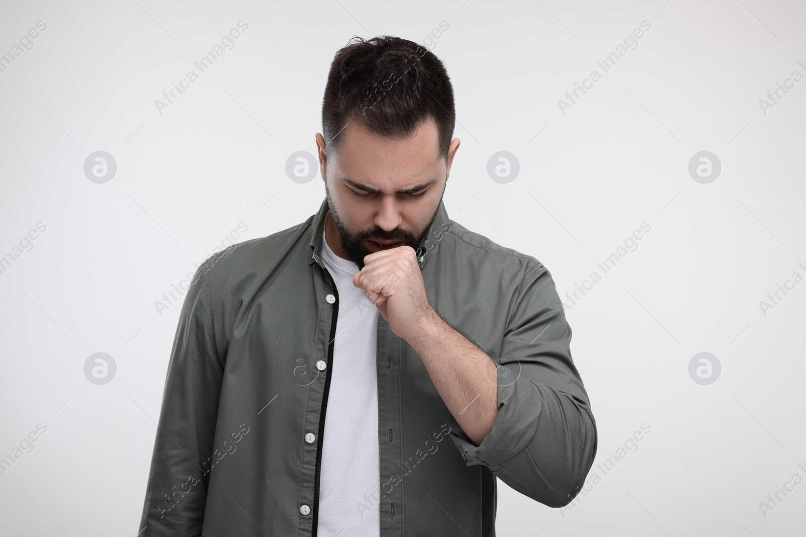 Photo of Sick man coughing on white background. Cold symptoms