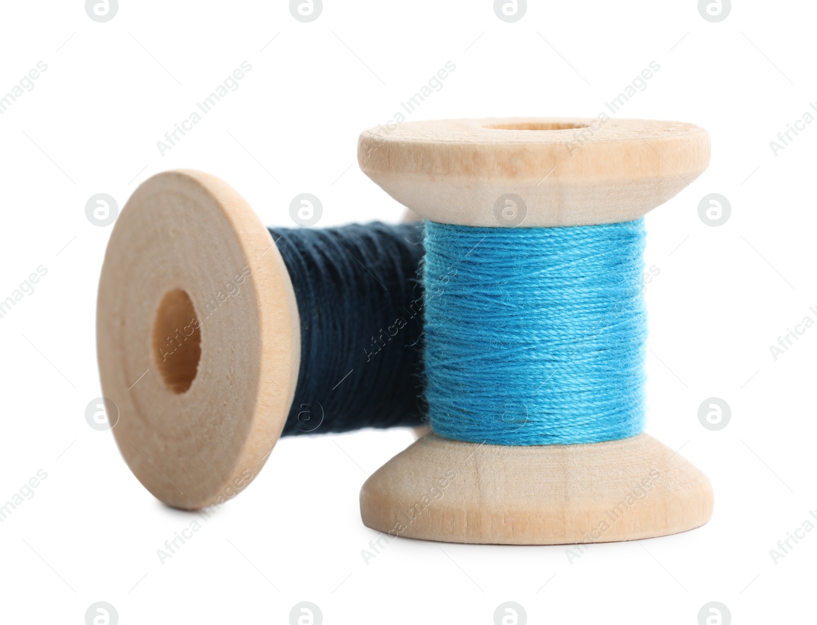 Photo of Different colorful sewing threads on white background, closeup