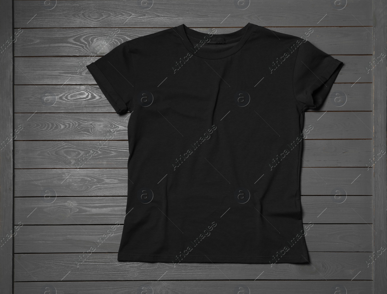Photo of Stylish black T-shirt on gray wooden table, top view