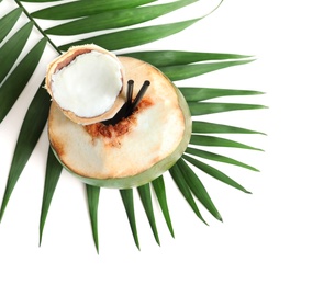 Fresh green coconut with drinking straws and palm leaf on white background