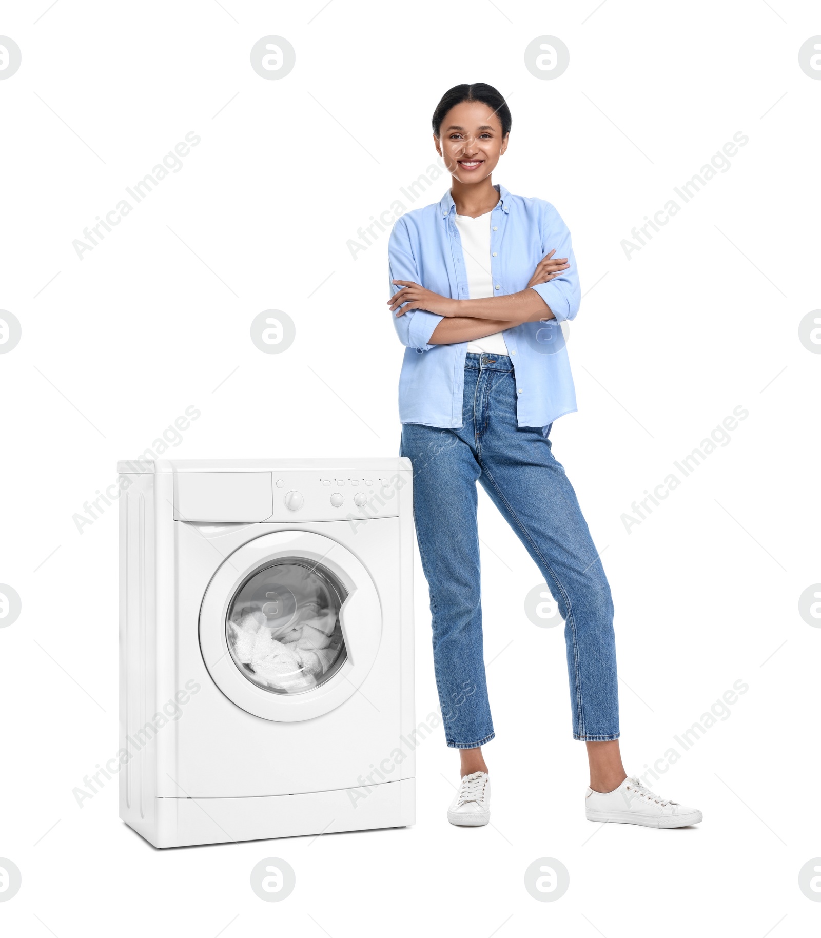 Photo of Beautiful woman near washing machine with laundry on white background