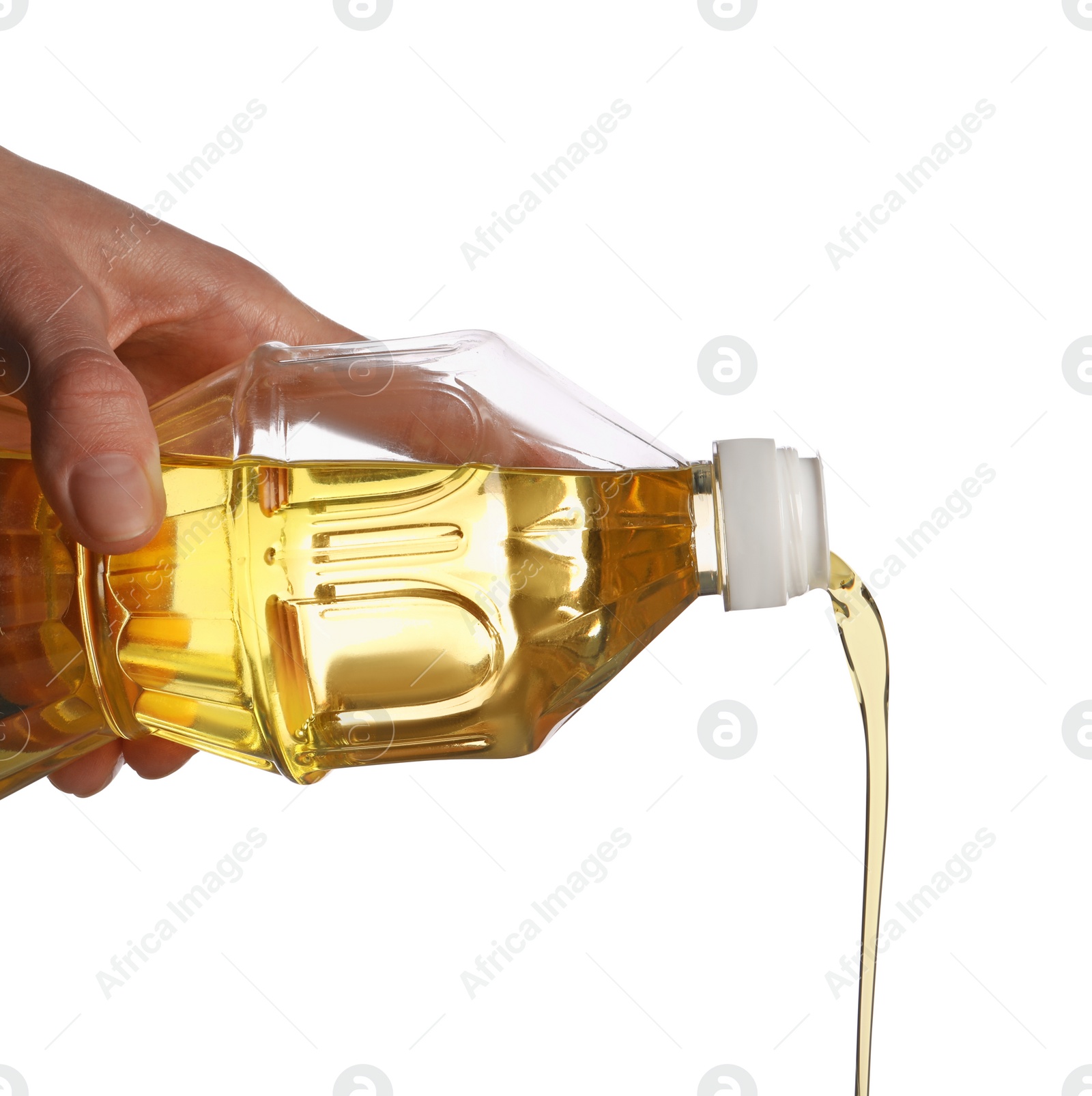 Photo of Pouring cooking oil from bottle on white background