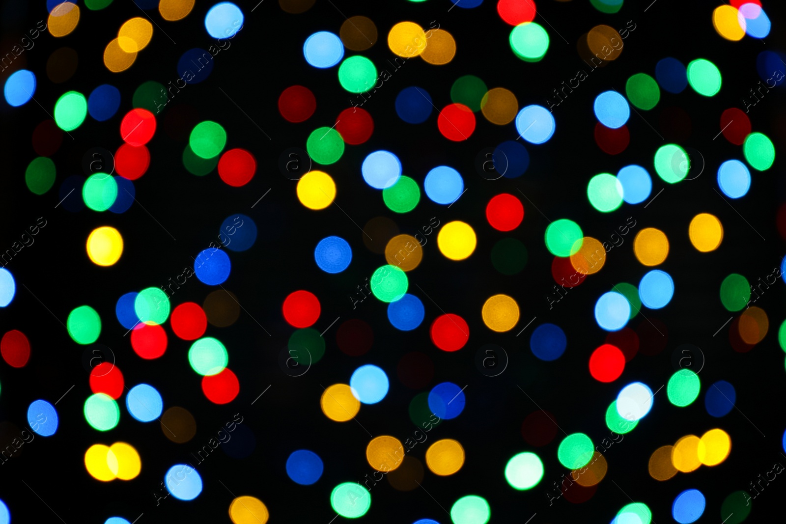 Photo of Multicolor blurred lights on black background. Bokeh effect