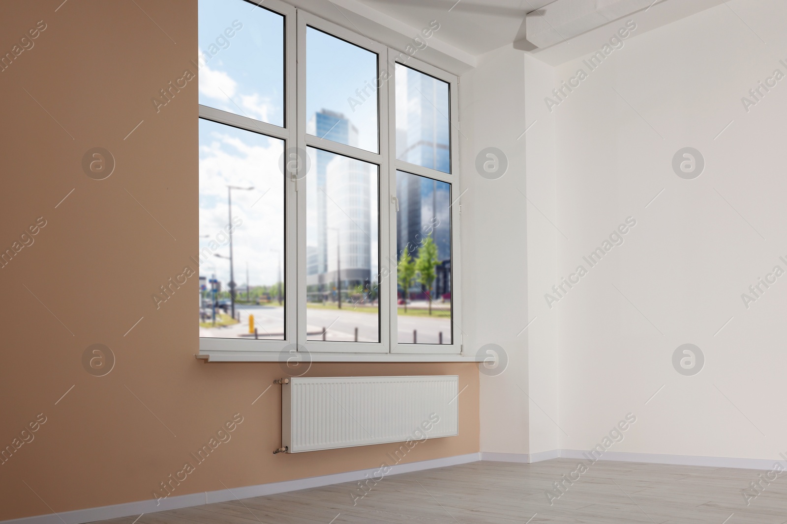 Photo of New empty room with clean windows and light walls