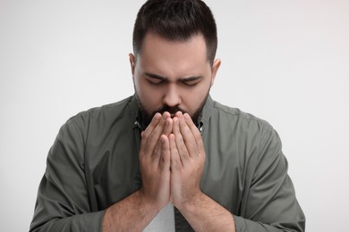 Photo of Sick man coughing on white background. Cold symptoms