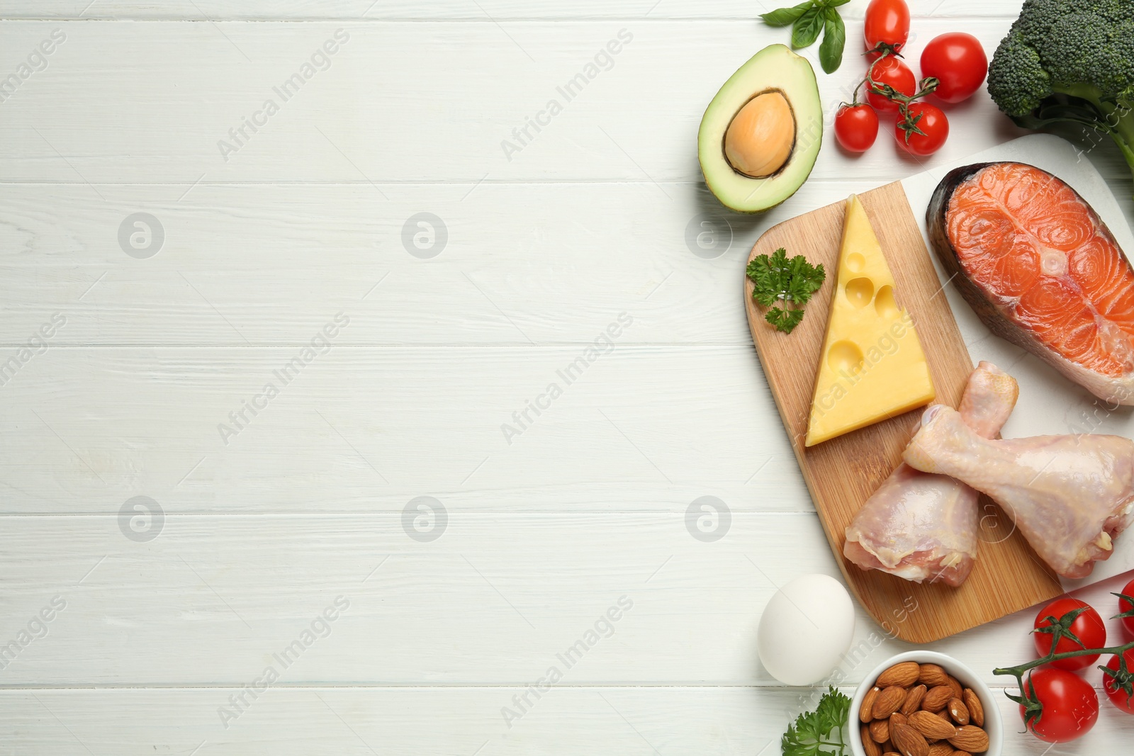 Photo of Flat lay composition with keto diet products on white wooden table, space for text