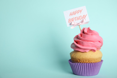 Beautiful birthday cupcake on light blue background. Space for text