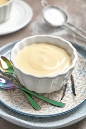 Photo of Bowl with vanilla pudding and sticks on plate