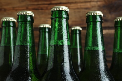 Bottles of beer on wooden background, closeup