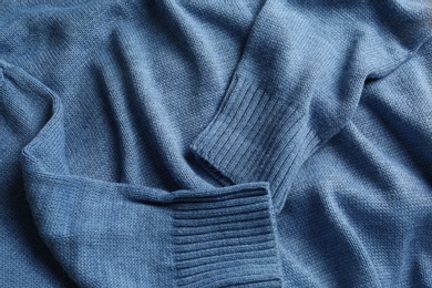 Soft stylish knitted sweater as background, closeup