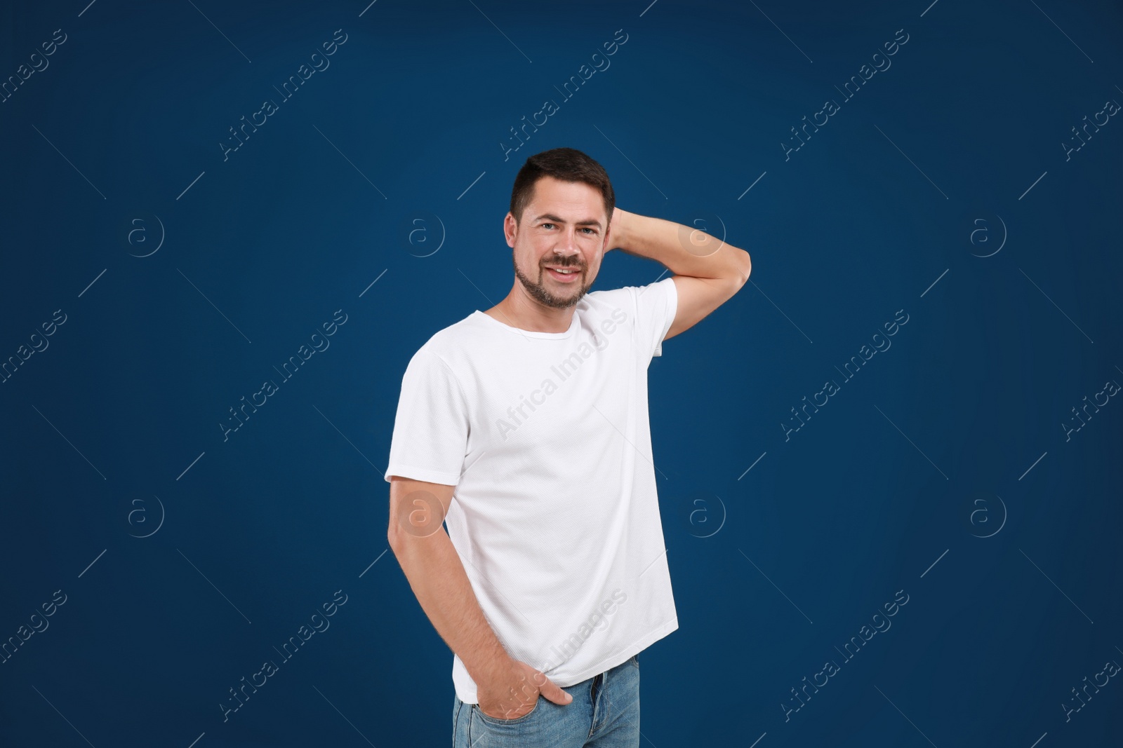 Photo of Portrait of handsome man on blue background