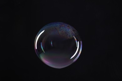 Photo of One beautiful soap bubble on black background