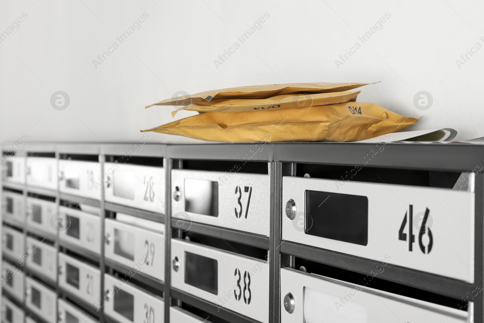 Photo of New mailboxes with keyholes, numbers, receipts and envelopes in post office