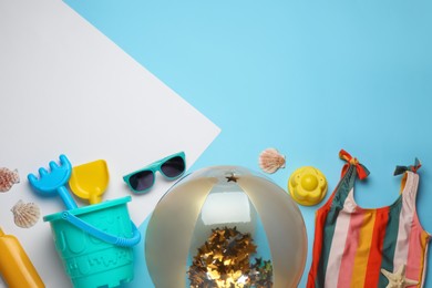 Photo of Flat lay composition with beach ball and sand toys on color background. Space for text