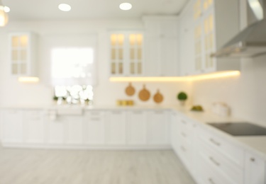 Photo of Blurred view of modern kitchen interior with stylish furniture