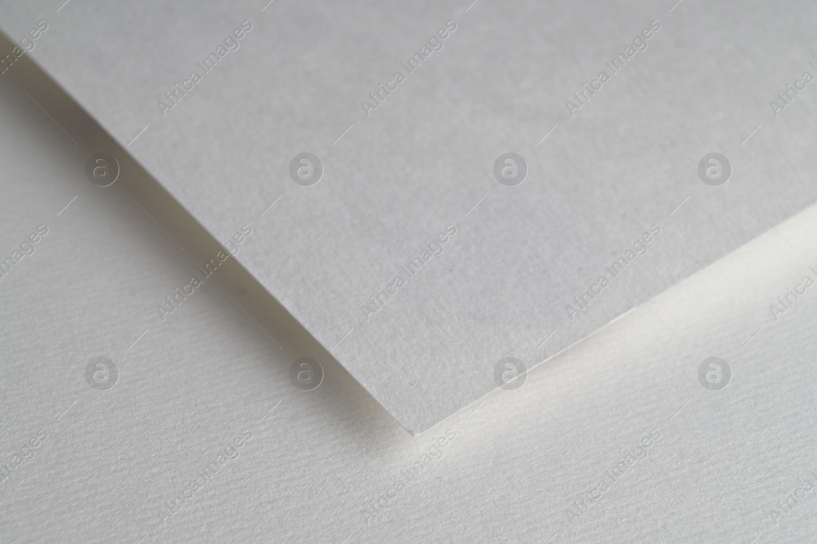 Photo of Blank watercolor paper sheet on white background, closeup