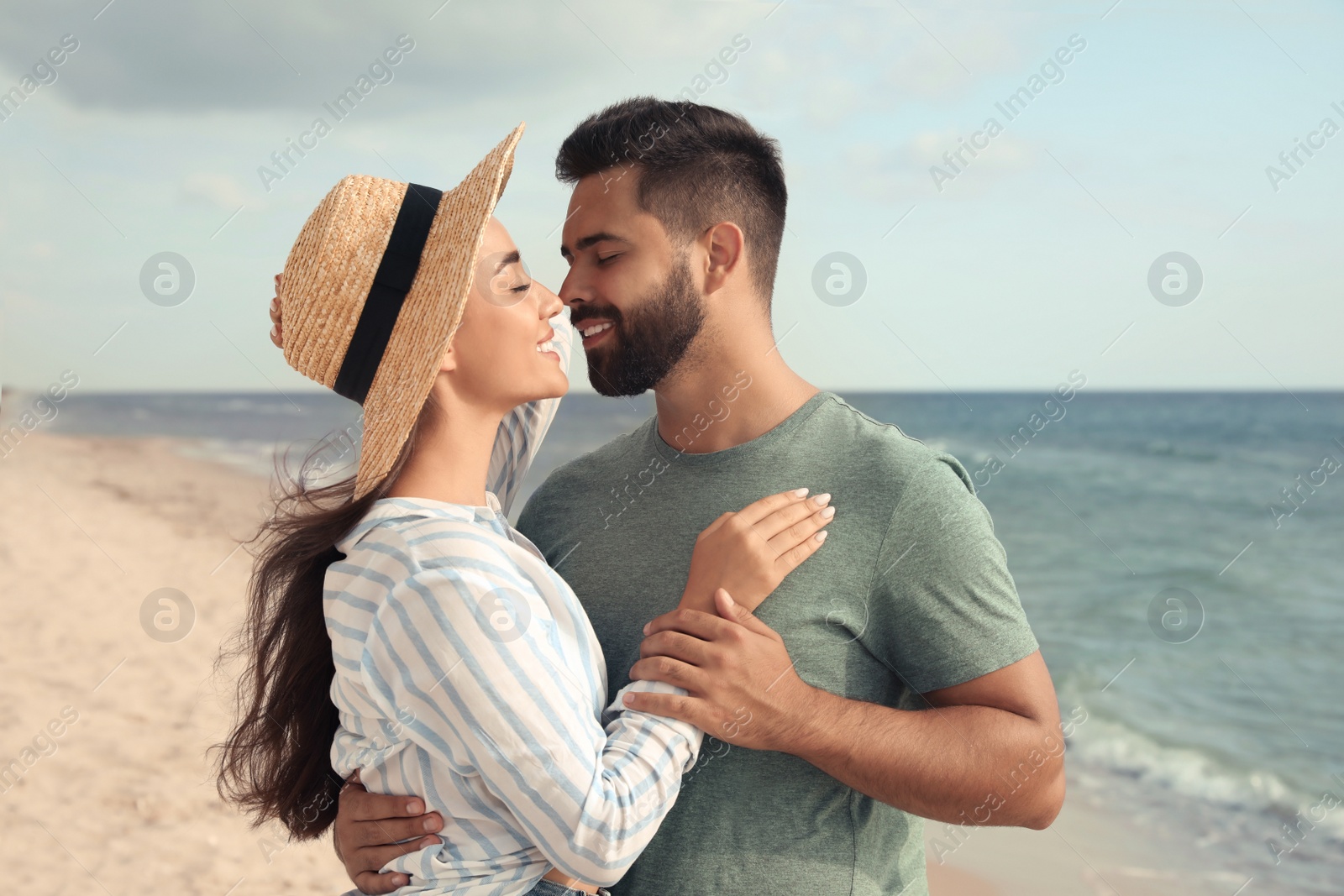 Photo of Lovely couple spending time together on beach