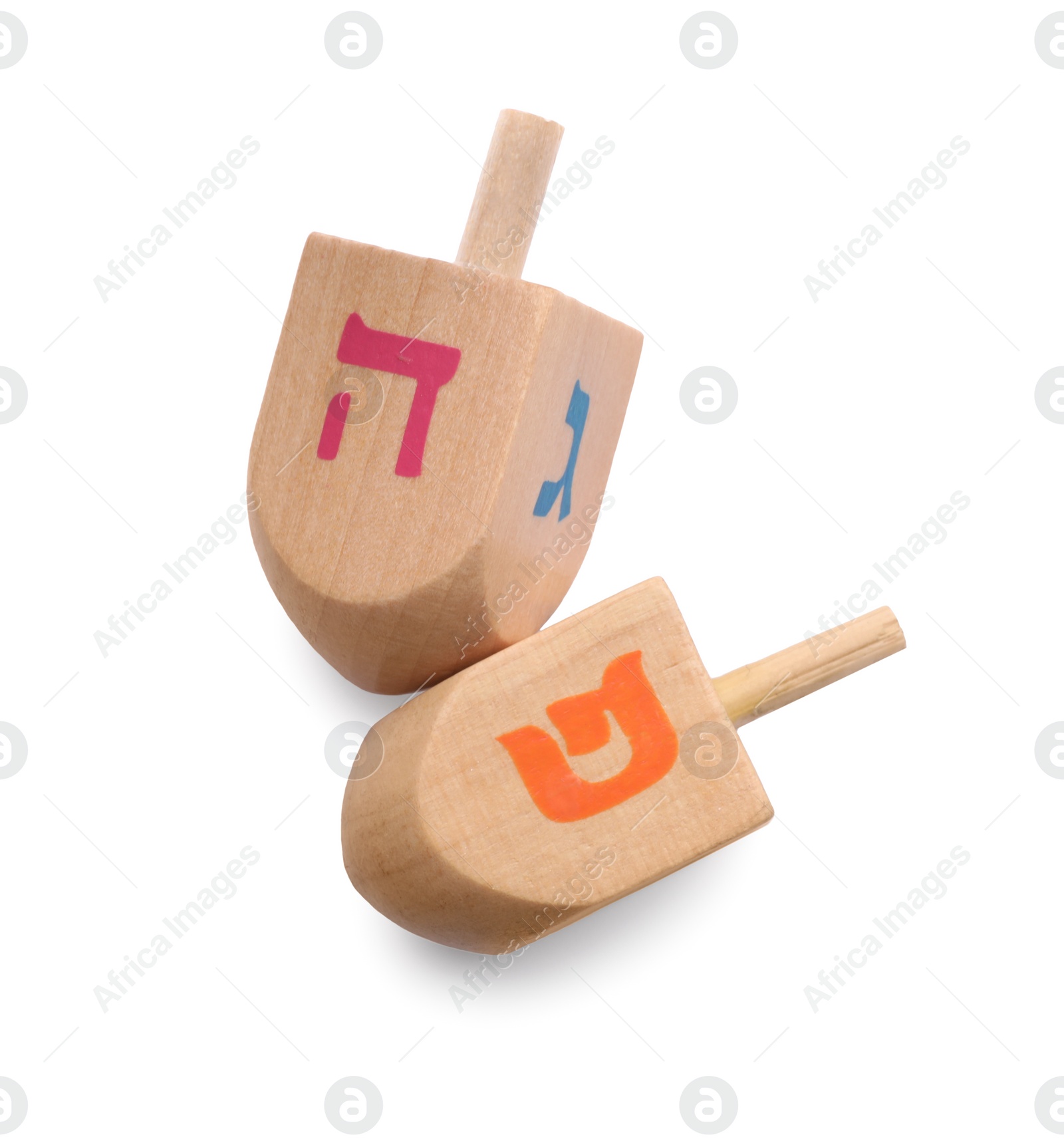 Photo of Wooden dreidels isolated on white, top view. Traditional Hanukkah game
